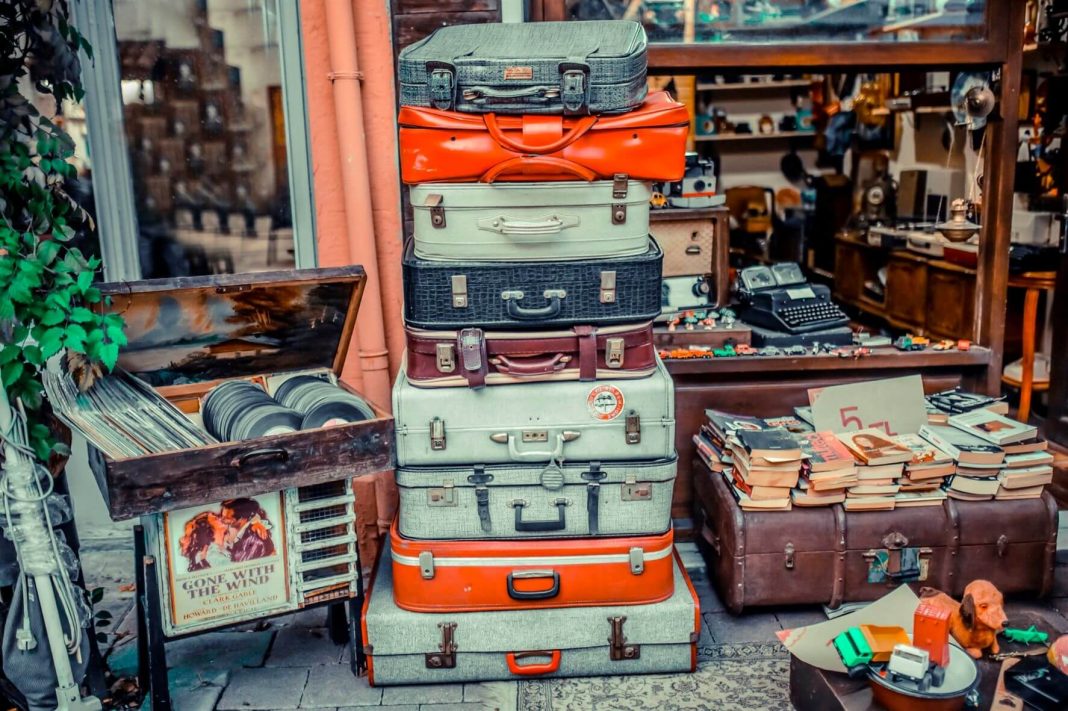 colorful old suitcases. old plaques and books