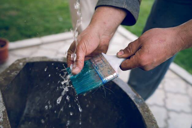 How to Make Paint Brushes Last Longer Water being used to remove paint from brush
