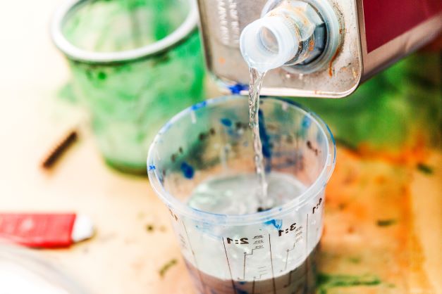 How to Make Paint Brushes Last Longer White spirit being used to remove paint from brushes