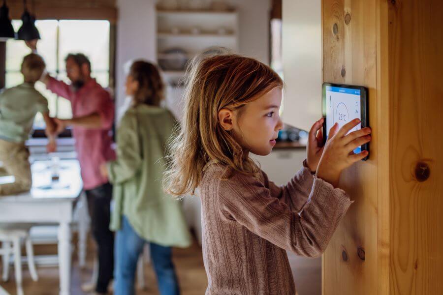 family using smart thermostat at home